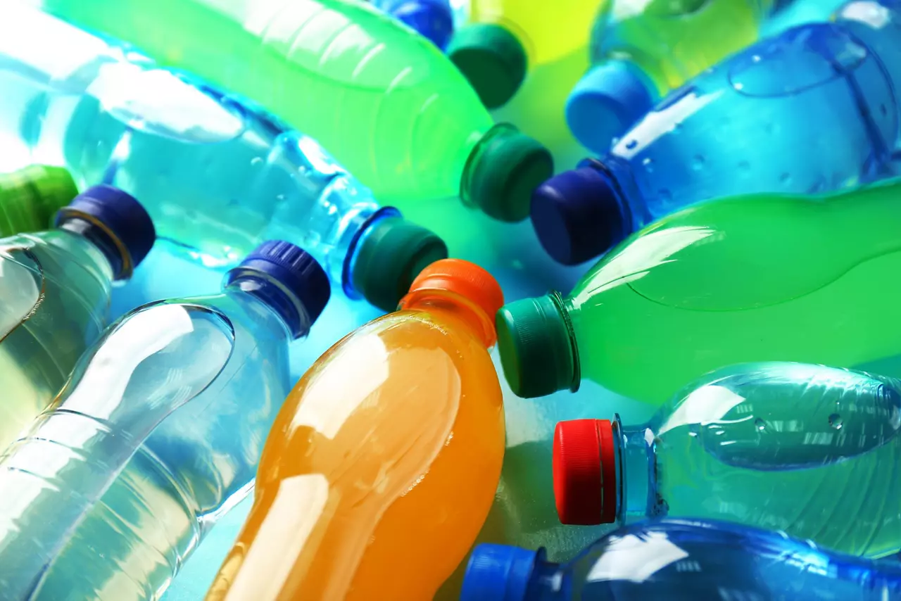 Various plastic bottles containing water as well as orange and green beverages
