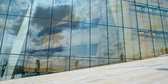 Closeup modern architecture wall made of blue toned glass and steel constructions