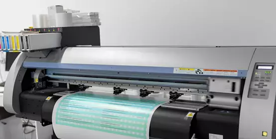 Label around a cylinder out of a machine