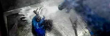 Person washing metal parts 