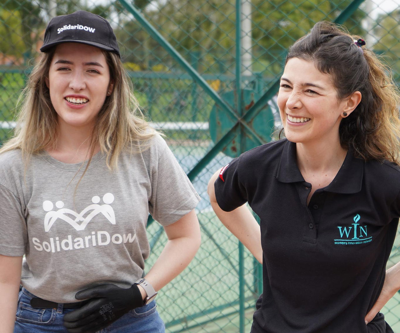 Two colleagues smile for a photo