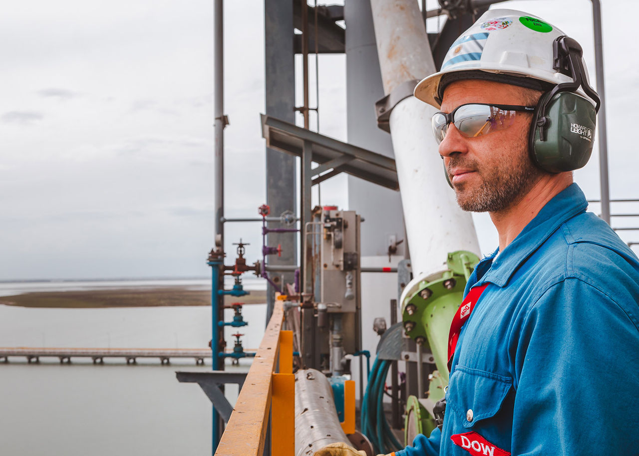 Dow employee looks out from tower in plant