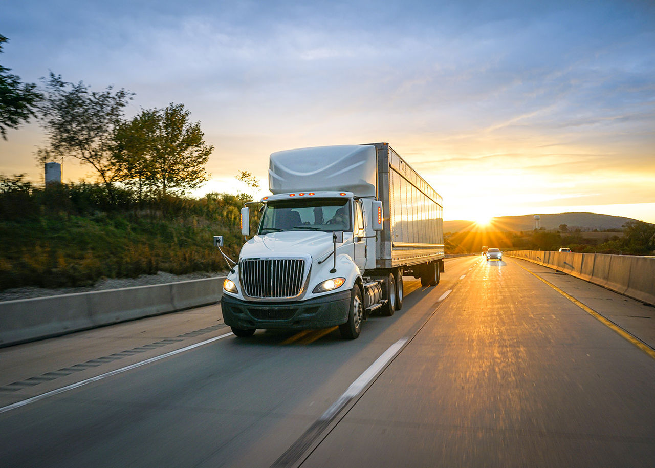 white semi truck driving on the road