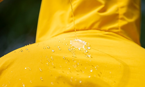 Raincoat with rain on it.