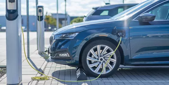 Electric vehicle charging at a station