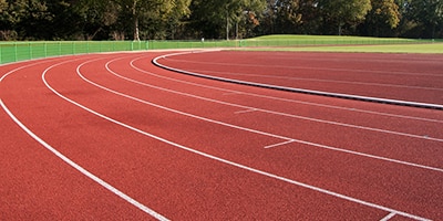 athletic track with trees in the background
