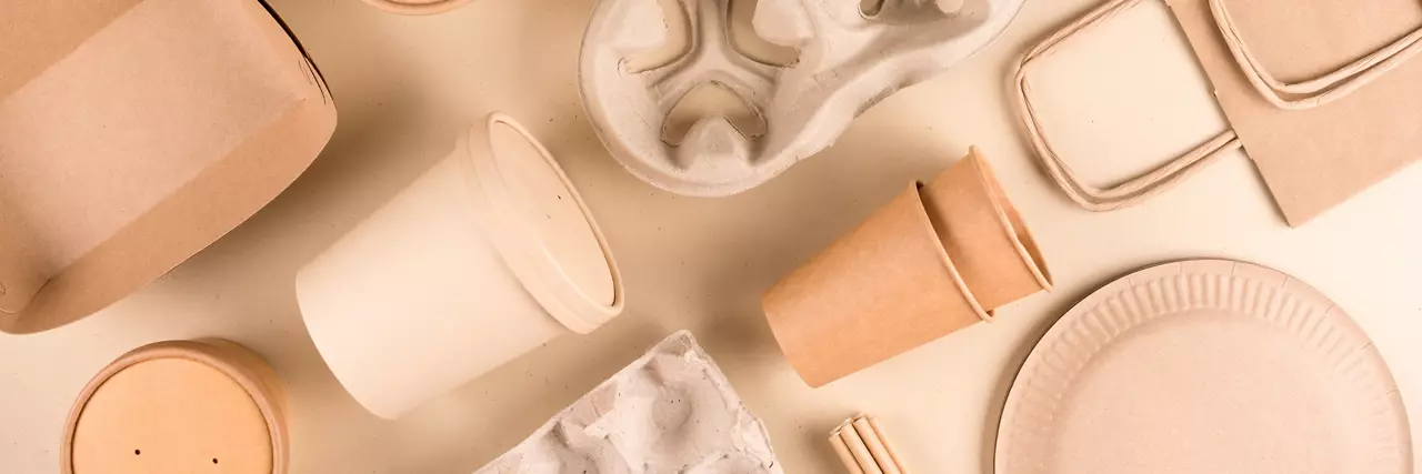 Paper disposable food service packaging on a yellow background