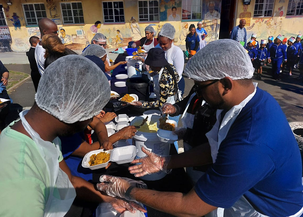 volunteers prepare food for a community event
